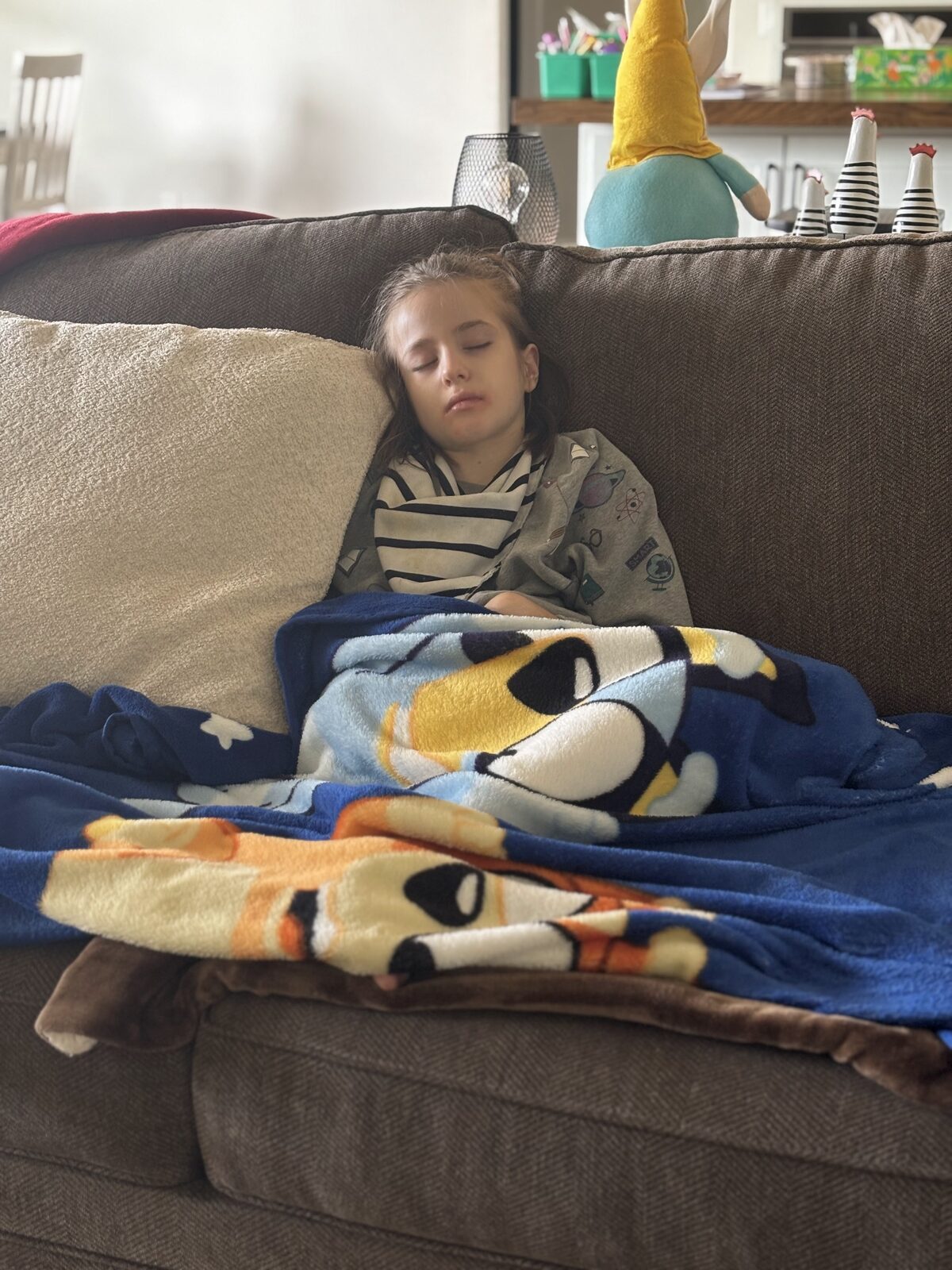 Brinlee resting at home, wrapped in a blanket